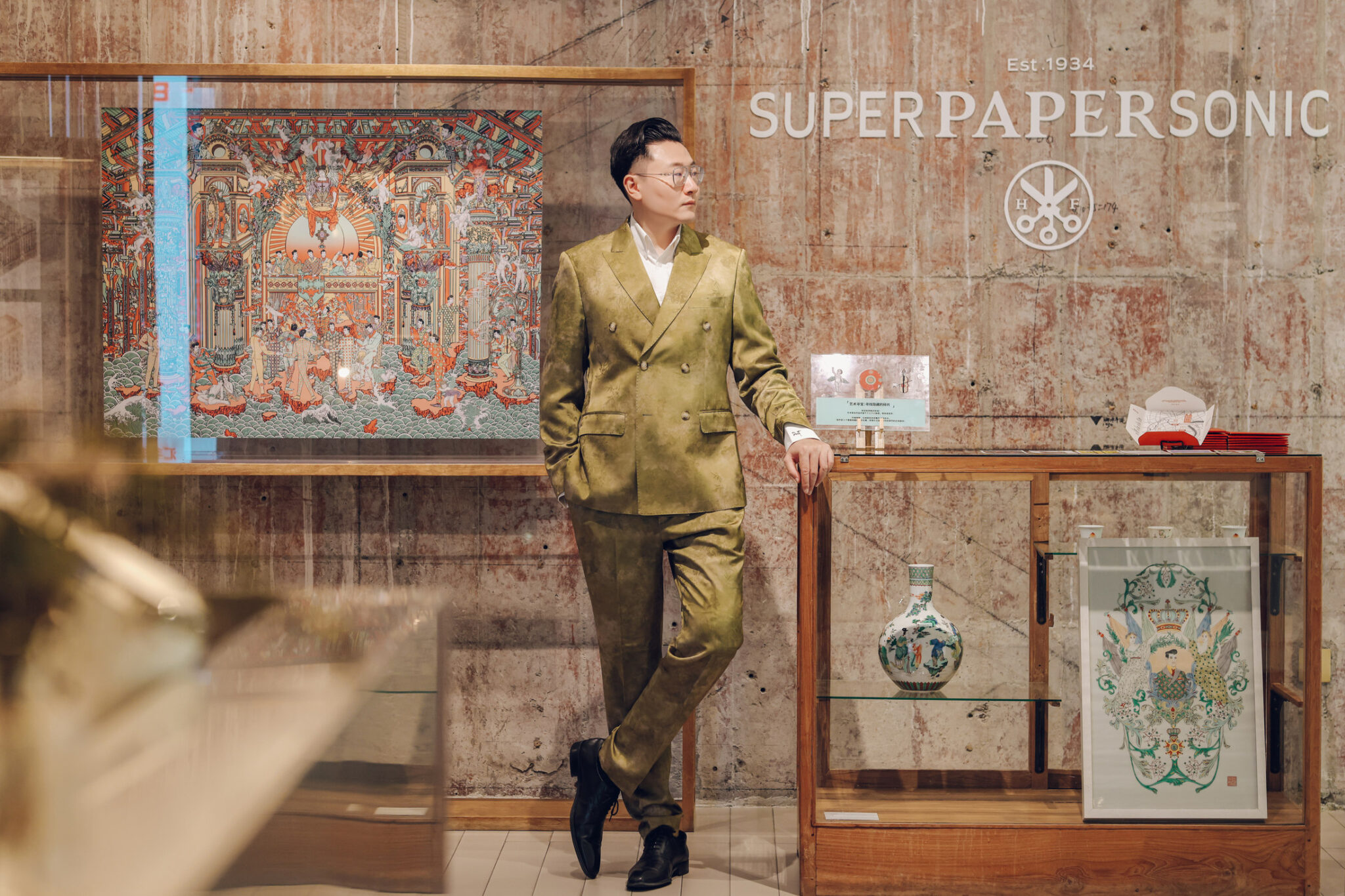Bin Feng with his artwork in an exhibition setting